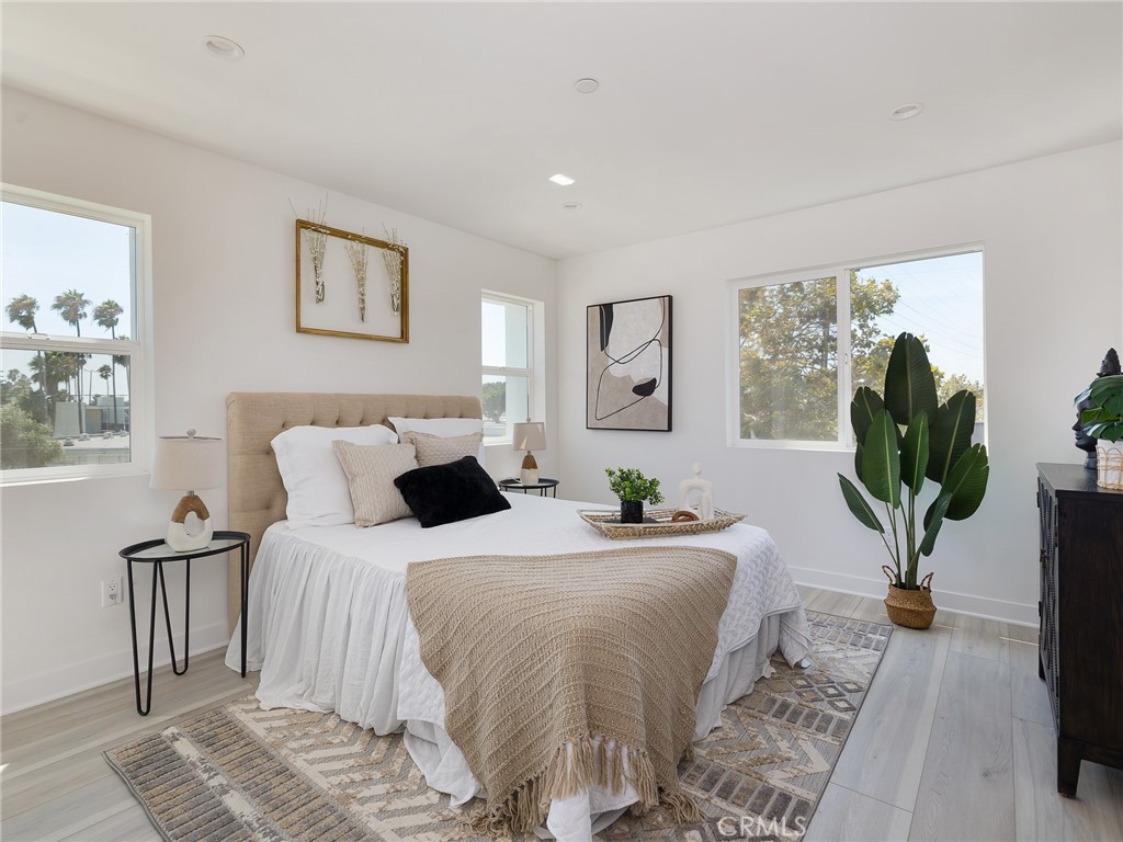 121 East 223rd Street, Unit 1 Carson, CA 90745 - Photo 15 of 35 a bedroom with bed and a potted plant