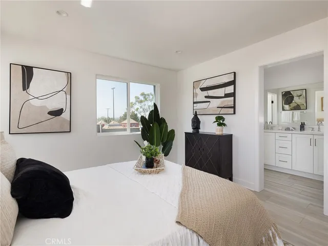 a living room with a couch and a potted plant