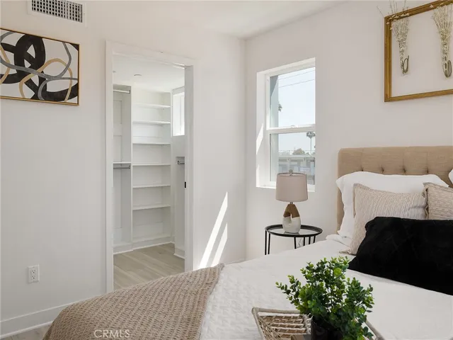 a bedroom with two beds and a couch