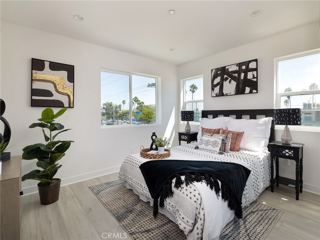 121 East 223rd Street, Unit 1 Carson, CA 90745 - Photo 19 of 35 a bed sitting in a bedroom next to a window with a flower pot