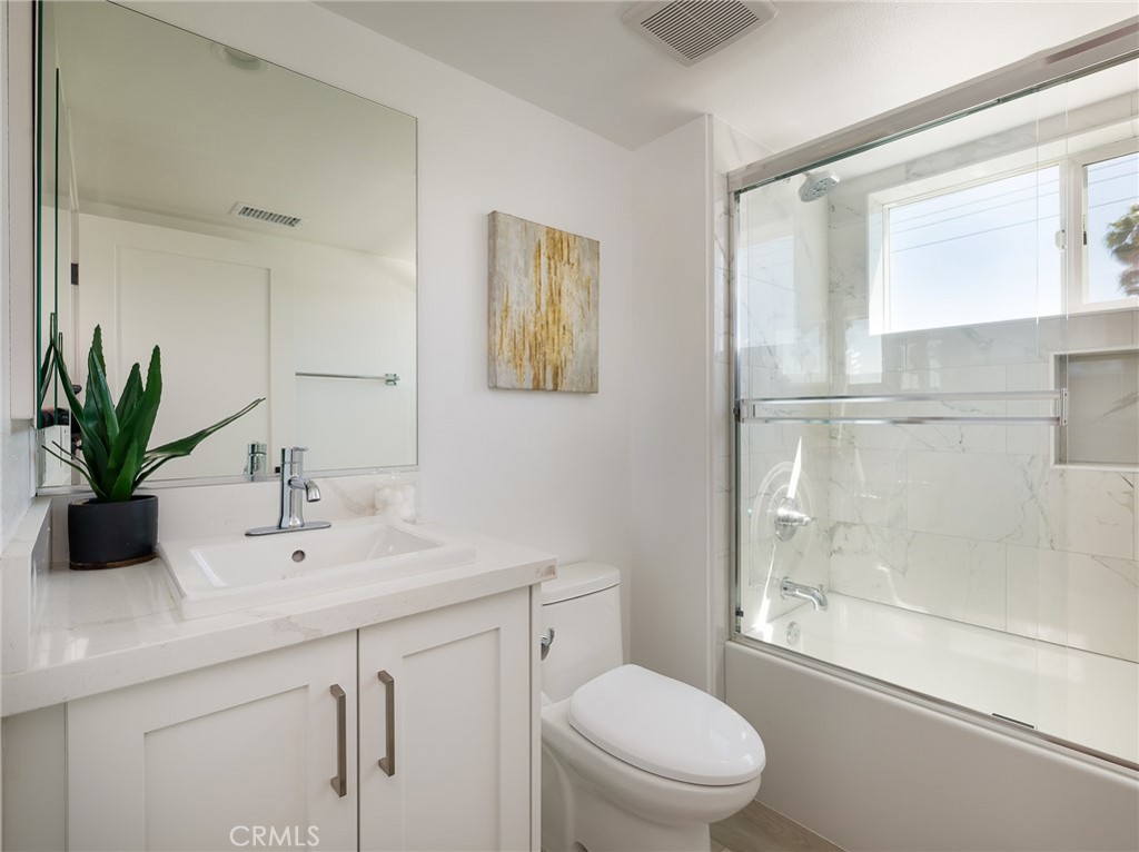 121 East 223rd Street, Unit 1 Carson, CA 90745 - Photo 21 of 35 a bathroom with a sink a mirror a toilet and shower