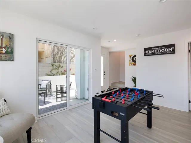 a view of a deck with table and chairs and potted plants