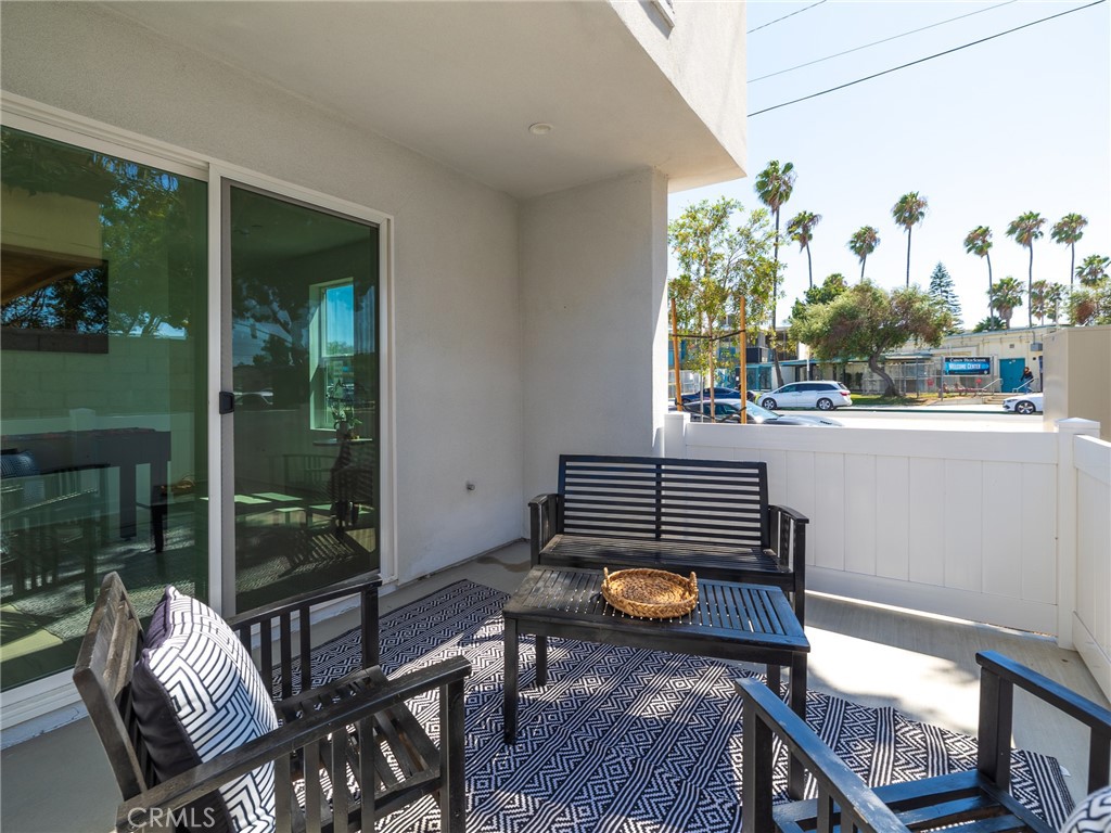 121 East 223rd Street, Unit 1 Carson, CA 90745 - Photo 25 of 35 a view of a deck with table and chairs and potted plants