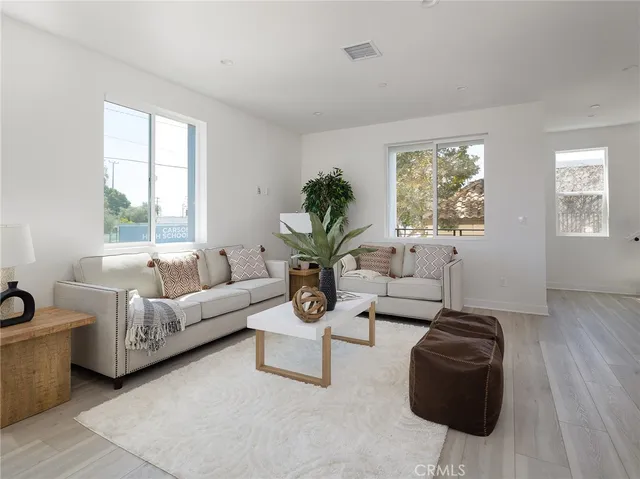 a kitchen with a sink a stove cabinets and chairs