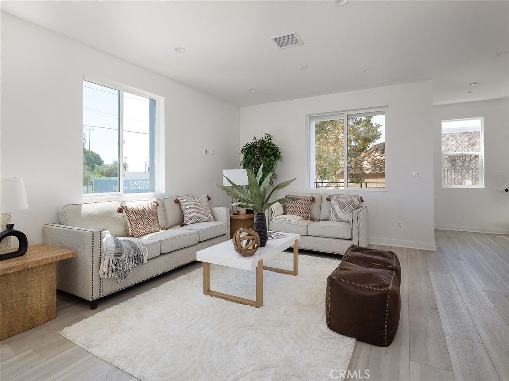 121 East 223rd Street, Unit 1 Carson, CA 90745 - Photo 7 of 35 a living room with furniture and a large window