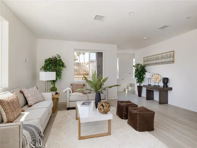 a kitchen with stainless steel appliances a dining table chairs and granite counter tops
