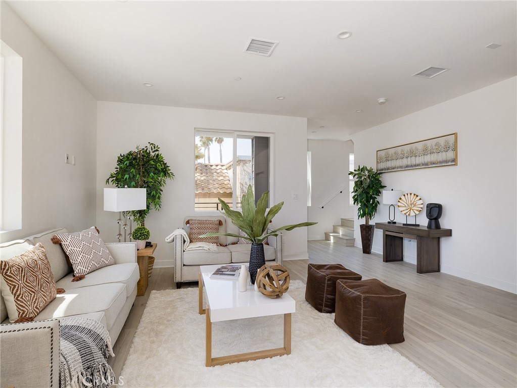 121 East 223rd Street, Unit 1 Carson, CA 90745 - Photo 8 of 35 a living room with furniture potted plant and a window