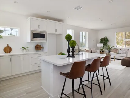 a kitchen with a white cabinets and white appliances