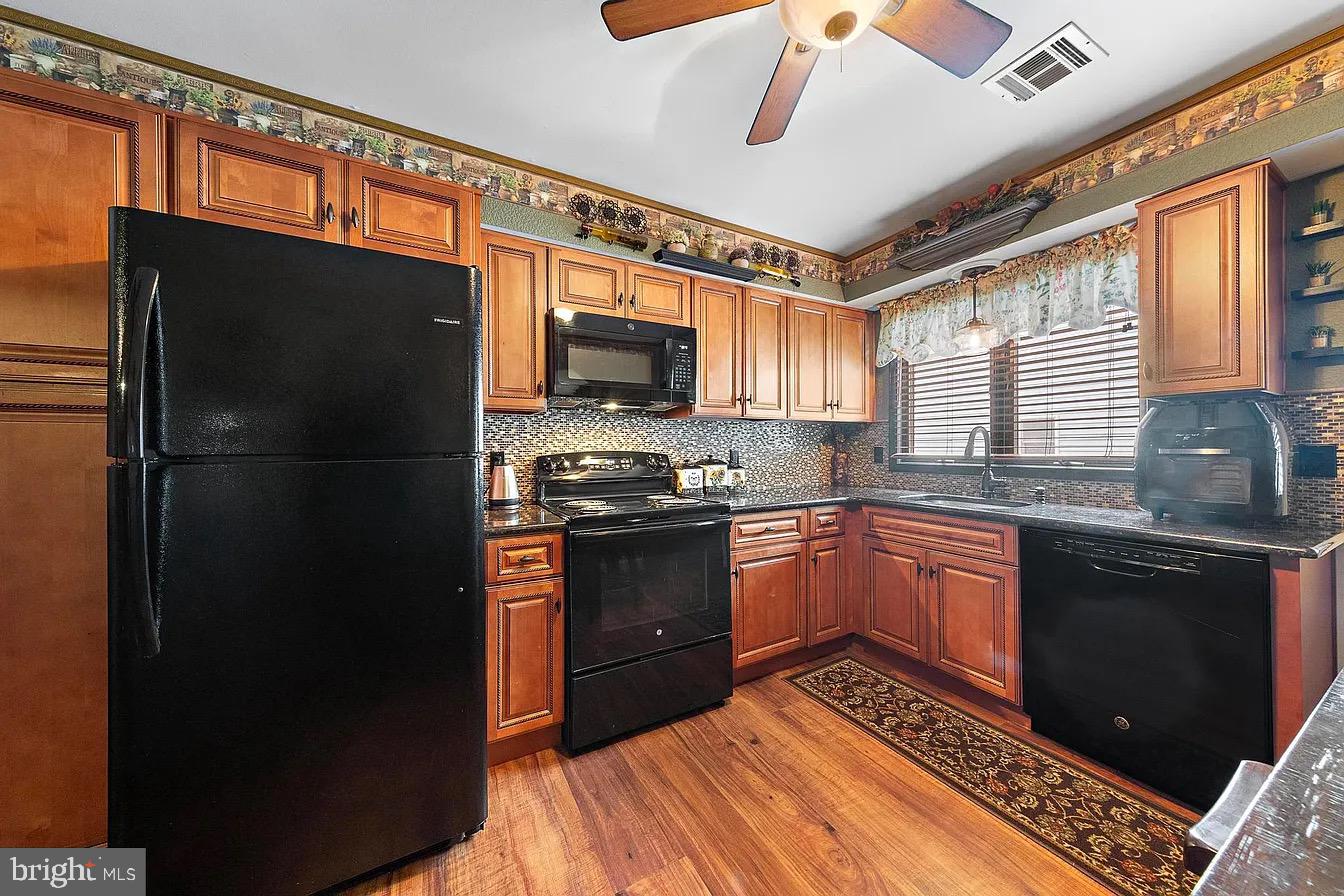 22 Fir Road Manahawkin, NJ 08050 - Photo 16 of 35 a kitchen with stainless steel appliances granite countertop a refrigerator a stove a sink and a microwave