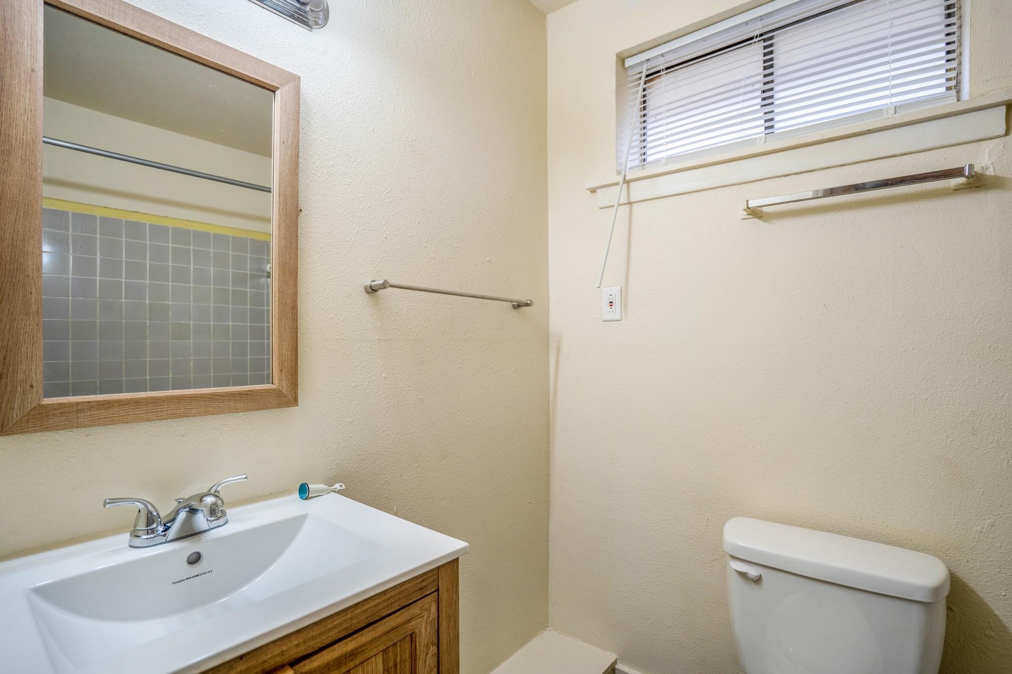 4720 Delano Street Houston, TX 77004 - Photo 11 of 12 a bathroom with a sink a toilet and vanity