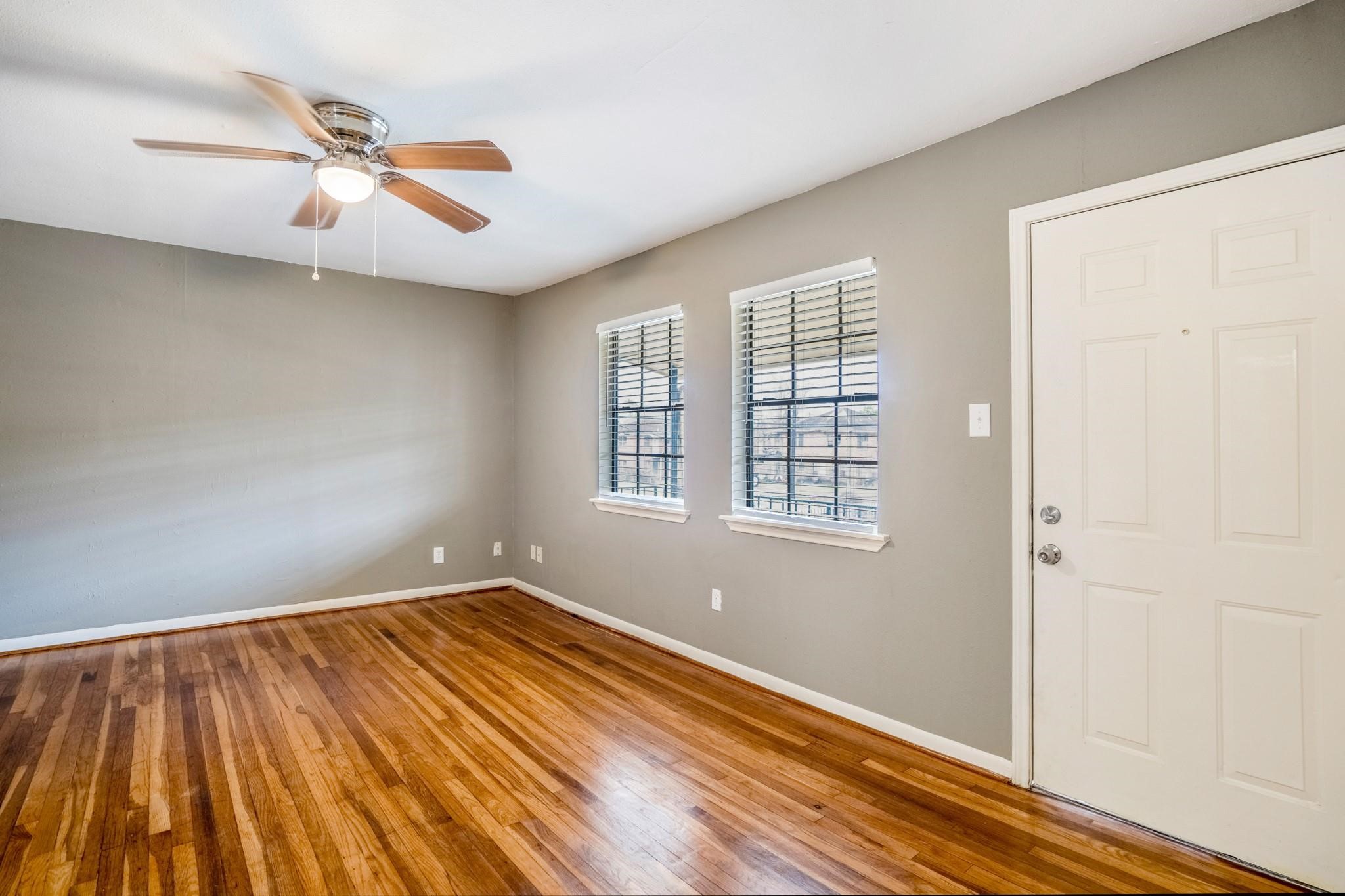 4720 Delano Street Houston, TX 77004 - Photo 2 of 12 wooden floor in an empty room with a window