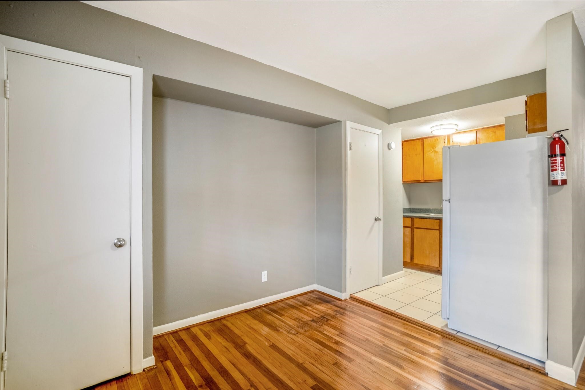 4720 Delano Street Houston, TX 77004 - Photo 3 of 12 a view of room with window and wooden floor