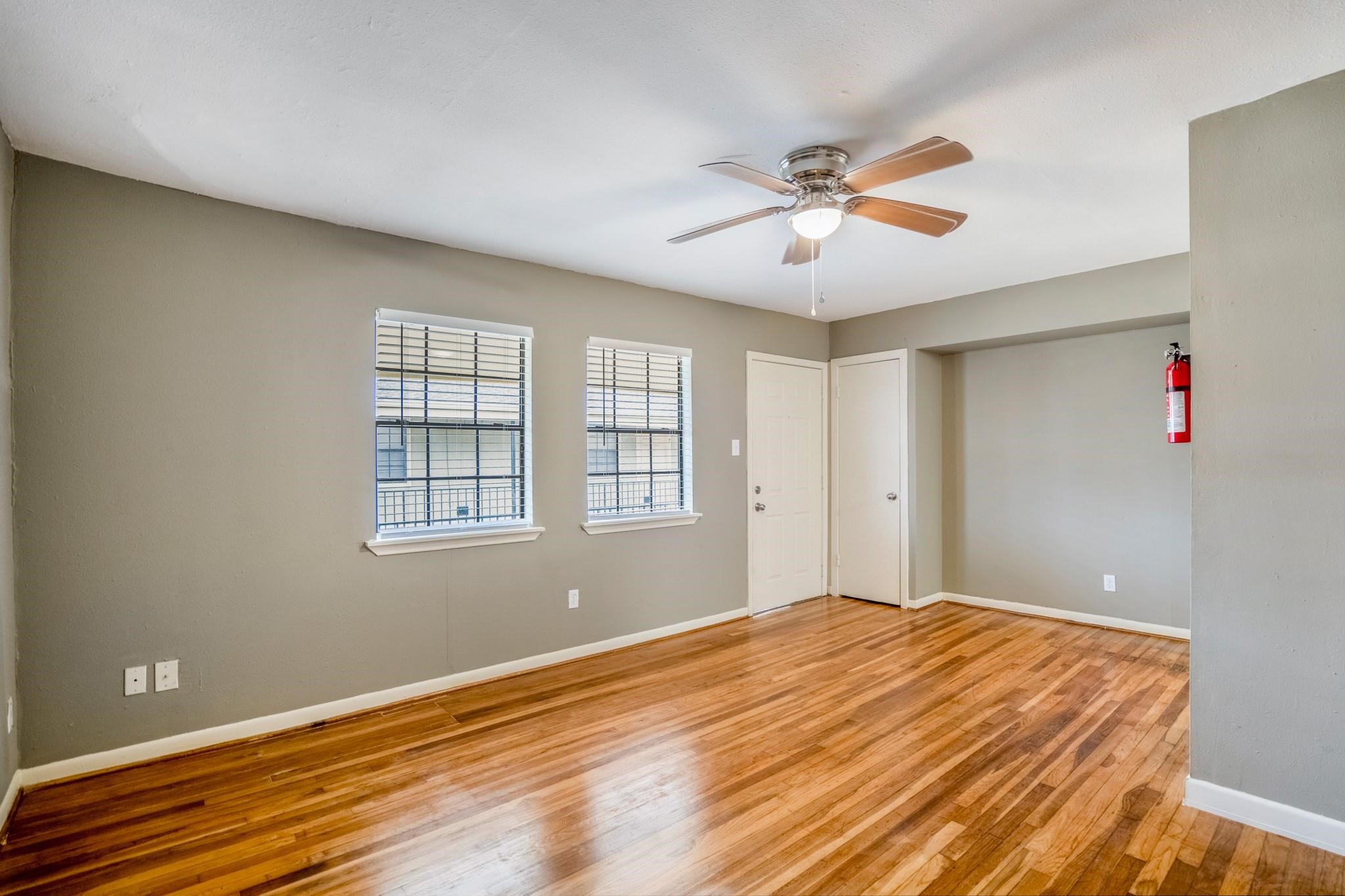 4720 Delano Street Houston, TX 77004 - Photo 4 of 12 a bedroom with a bed and a chandelier fan