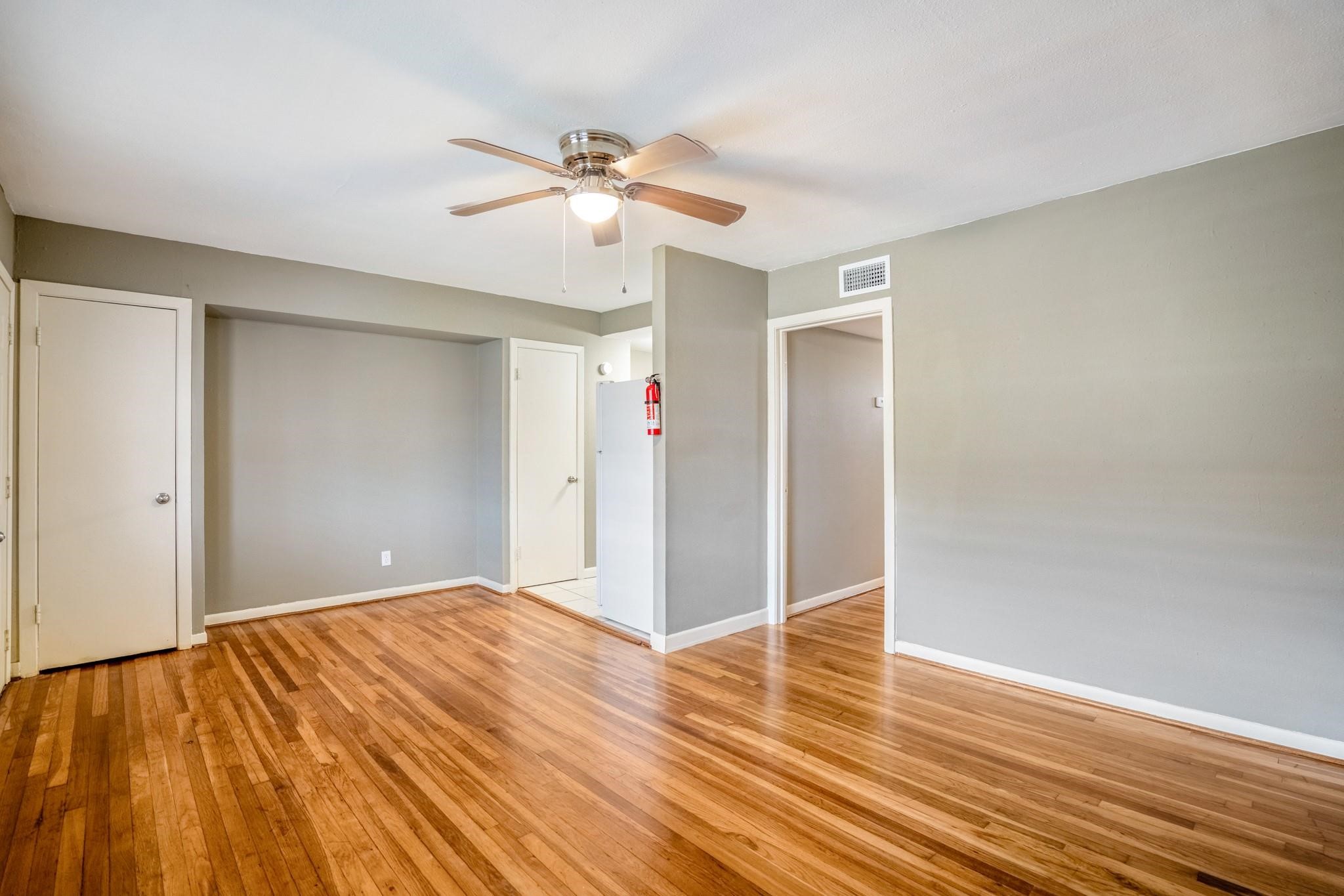 4720 Delano Street Houston, TX 77004 - Photo 5 of 12 a view of an empty room and wooden floor