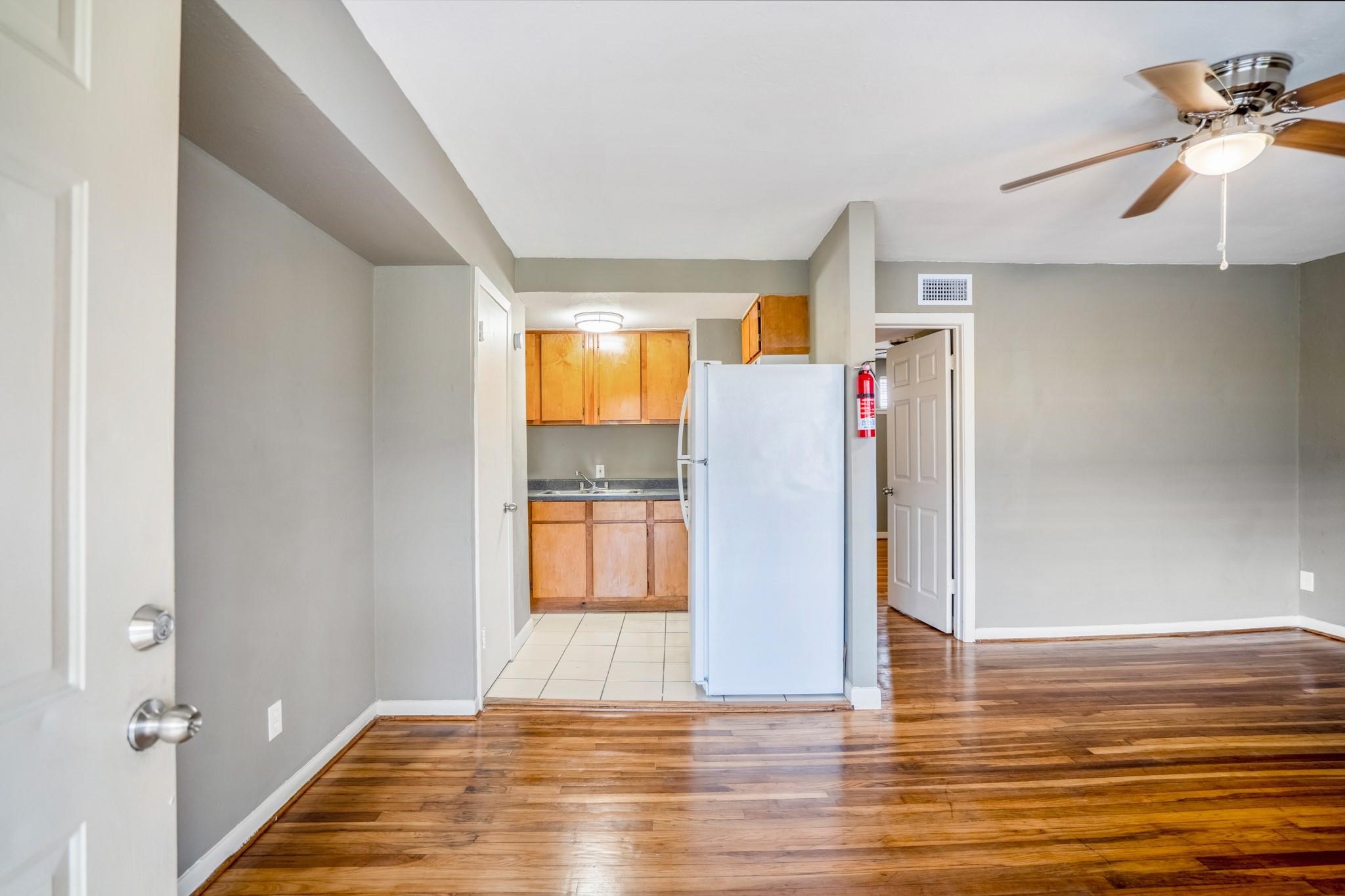 4720 Delano Street Houston, TX 77004 - Photo 6 of 12 a view of empty room with wooden floor and fan