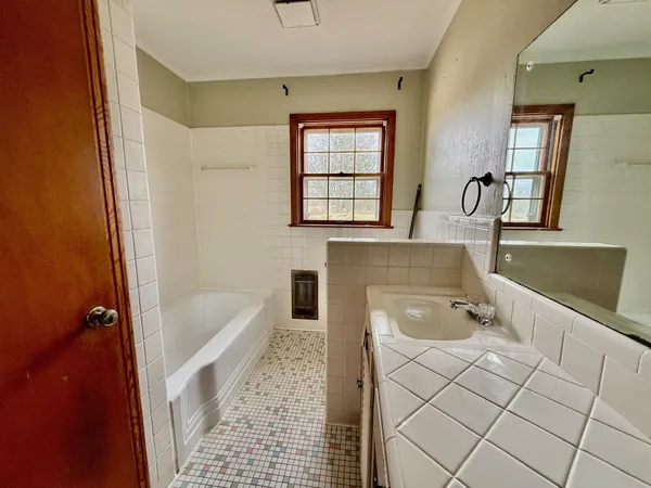 a bath room with a sink and a bath tub