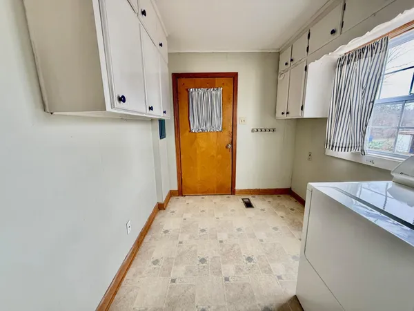 a view of a kitchen with wooden floor
