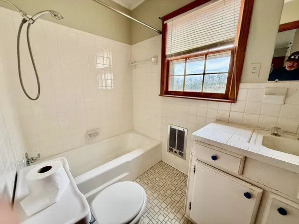 a bathroom with a sink a toilet and a bathtub