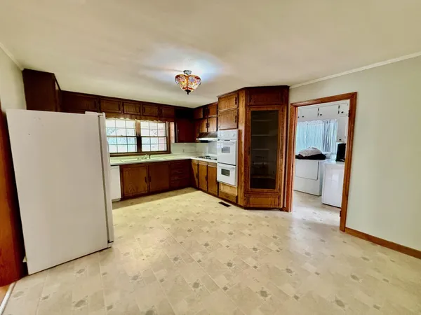 a view of kitchen with refrigerator and window