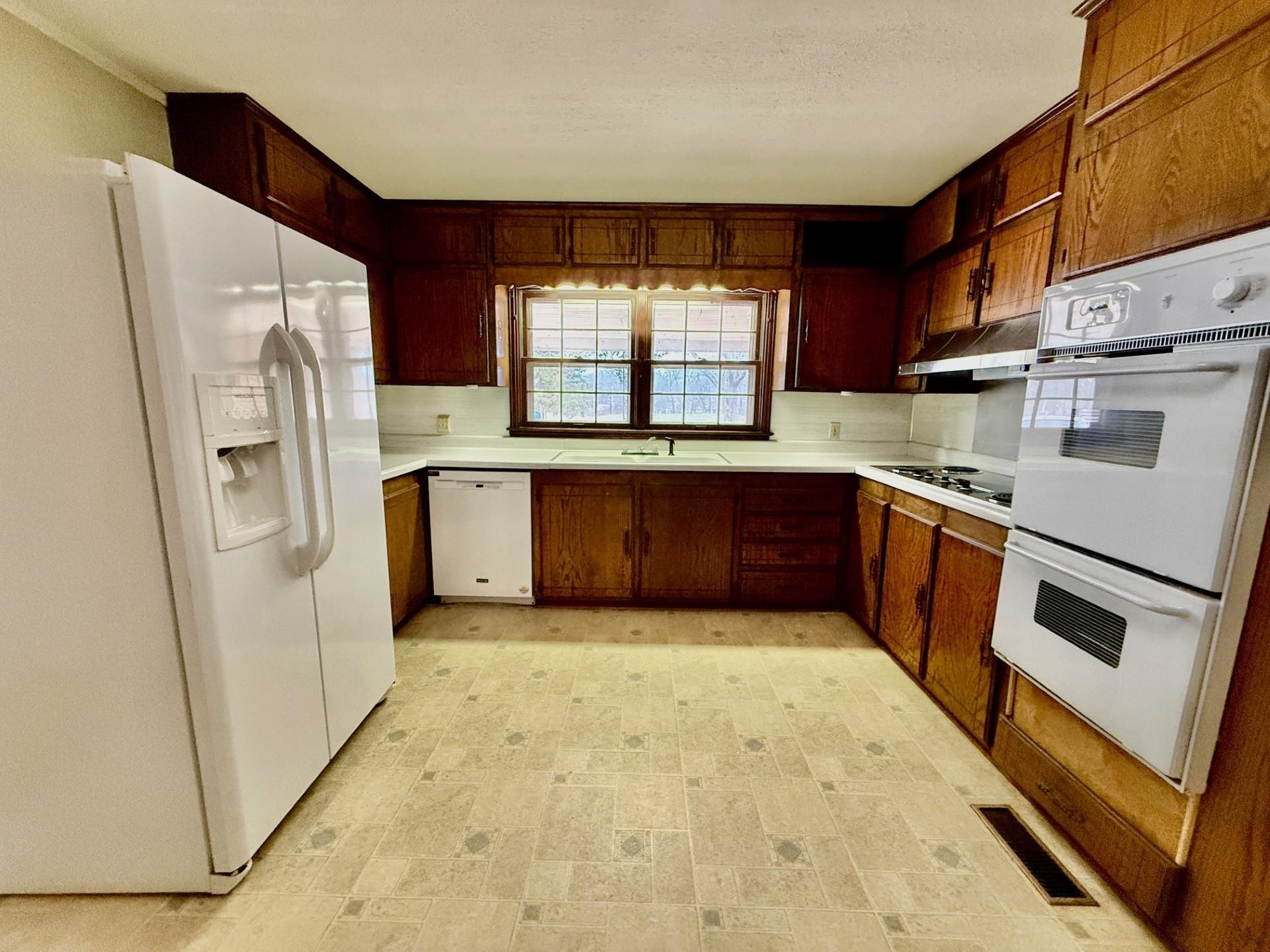 1880 Atoka Idaville Road Atoka, TN 38004 - Photo 7 of 15 a kitchen with stainless steel appliances granite countertop a refrigerator a sink a stove and island