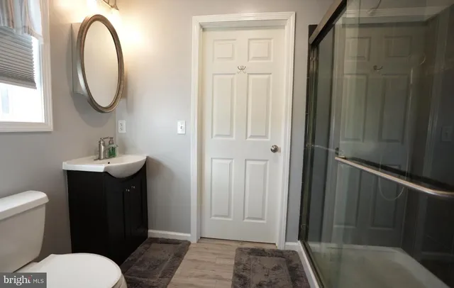 a bathroom with a toilet a sink and a mirror