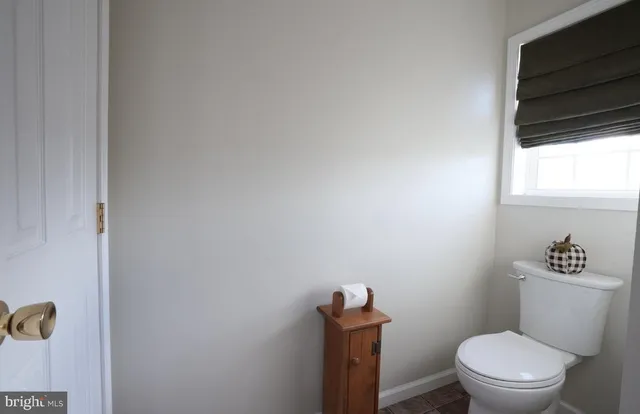 a white toilet sitting next to a bathroom sink