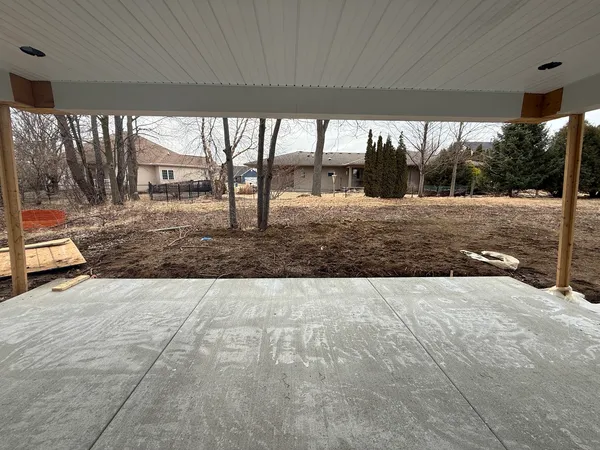 a view of a backyard with large trees