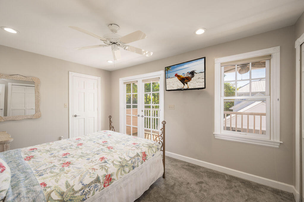 202 Admirals Lane Key West, FL 33040 - Photo 31 of 59 a bedroom with a bed and a window