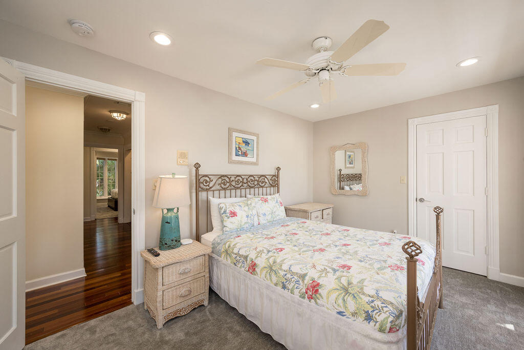 202 Admirals Lane Key West, FL 33040 - Photo 32 of 59 a bedroom with a large bed and a chandelier