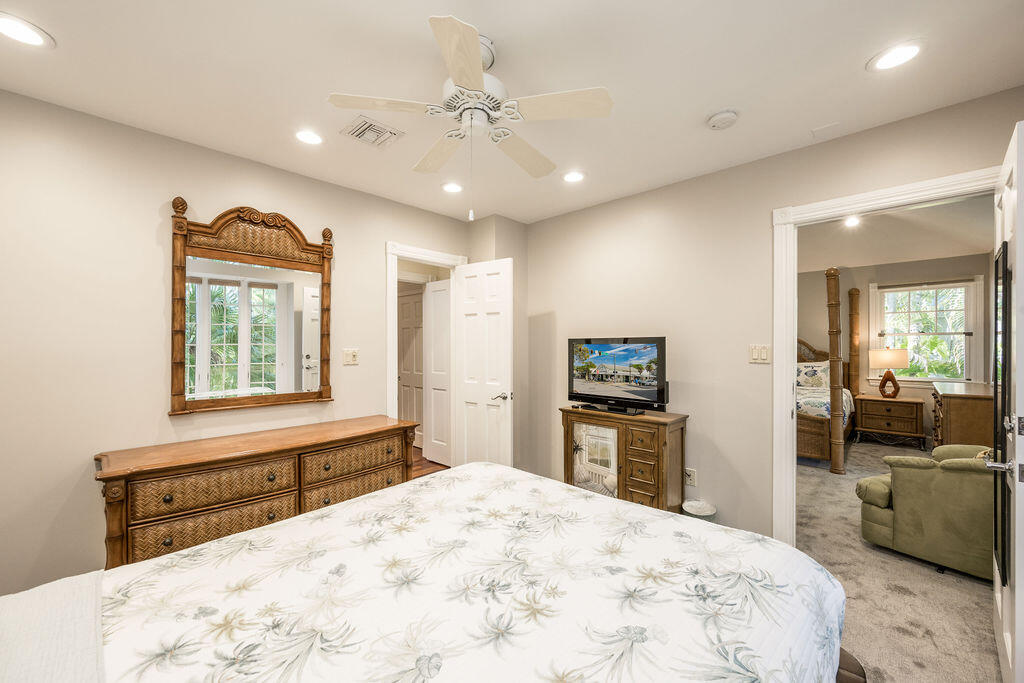 202 Admirals Lane Key West, FL 33040 - Photo 50 of 57 a bedroom with a bed and a large mirror with a flat tv screen