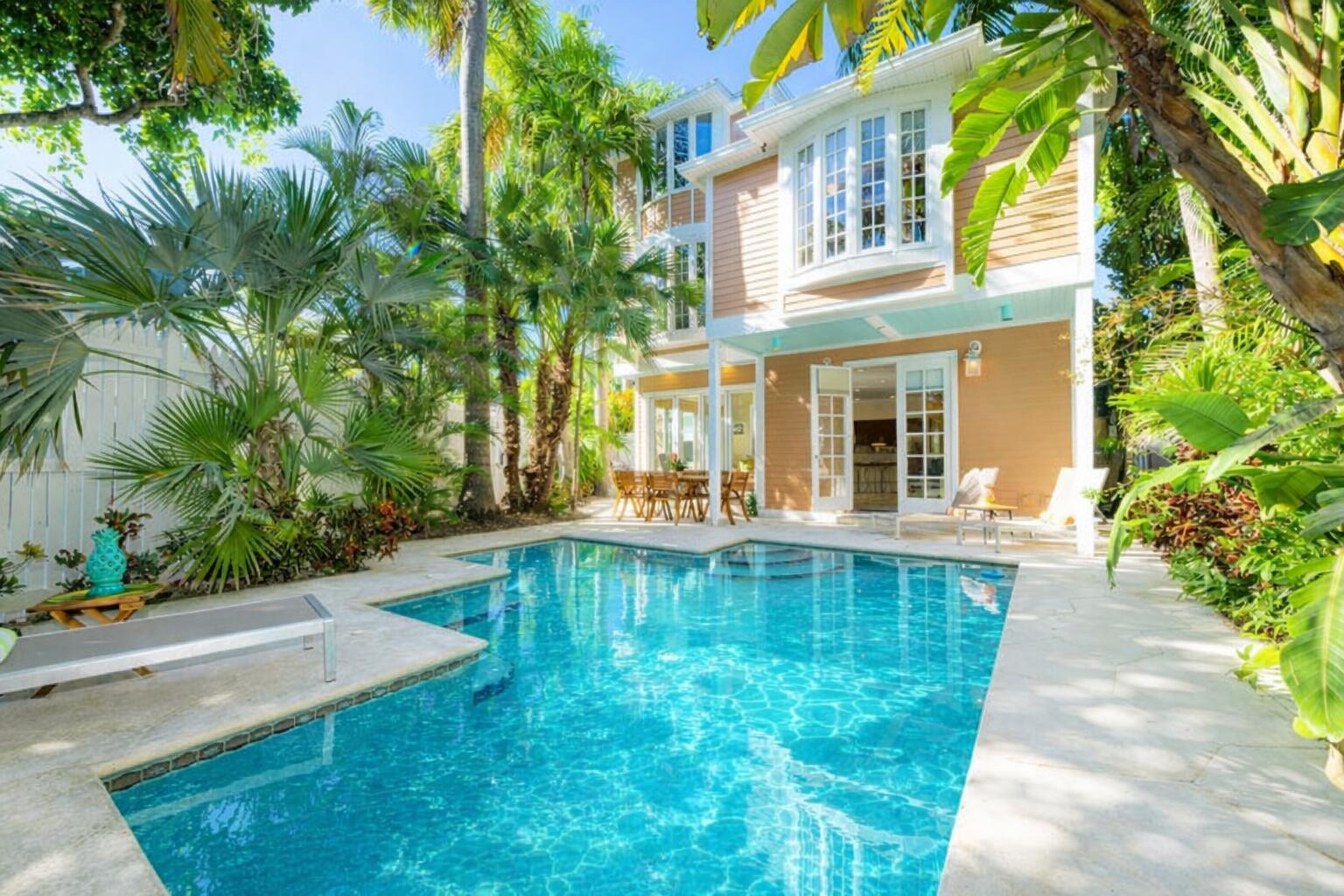 202 Admirals Lane Key West, FL 33040 - Photo 8 of 57 a view of a swimming pool with two chairs in patio