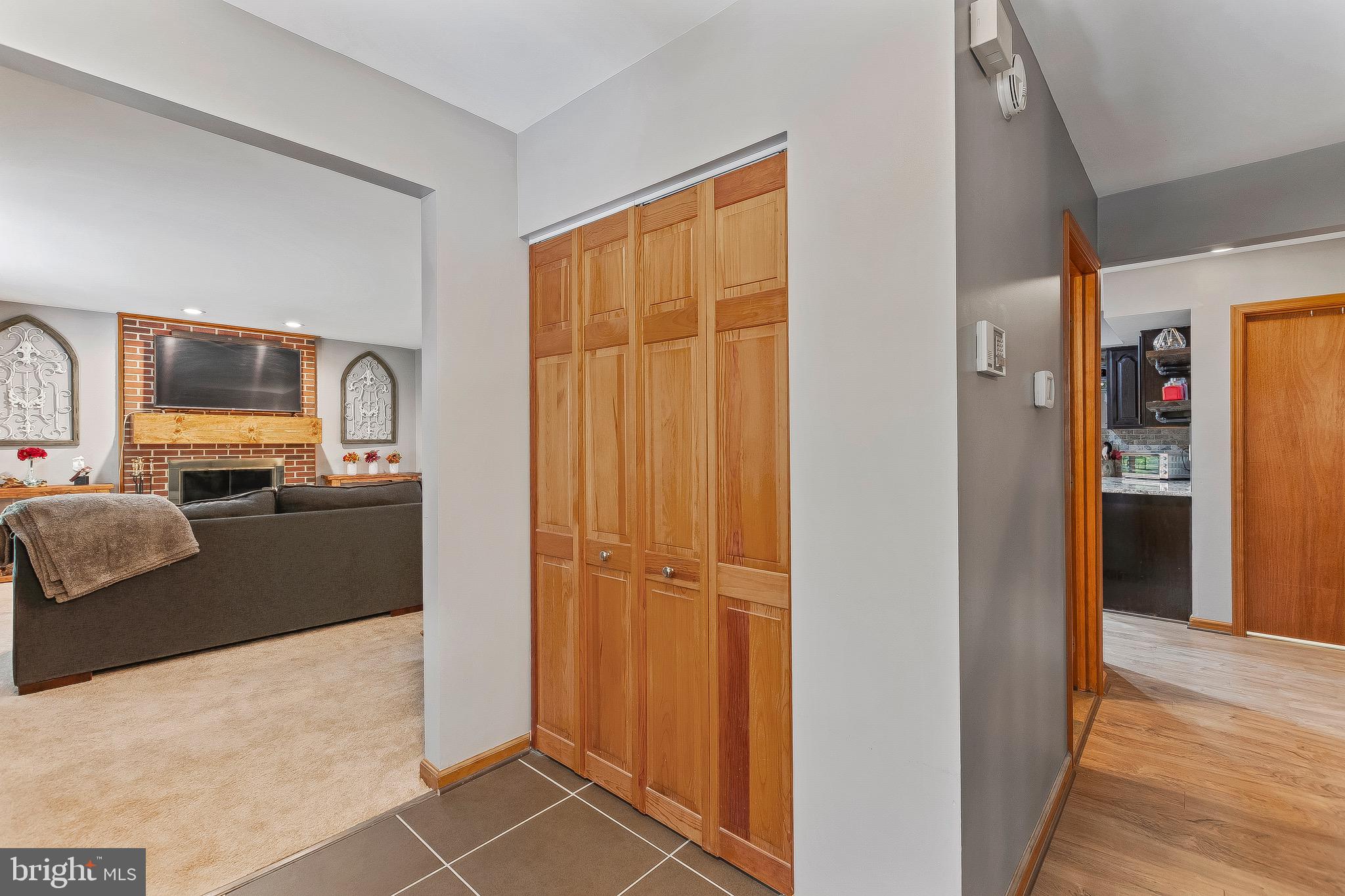 2415 Stoakley Road Prince Frederick, MD 20678 - Photo 10 of 42 a view of a livingroom with wooden floor windows and a kitchen