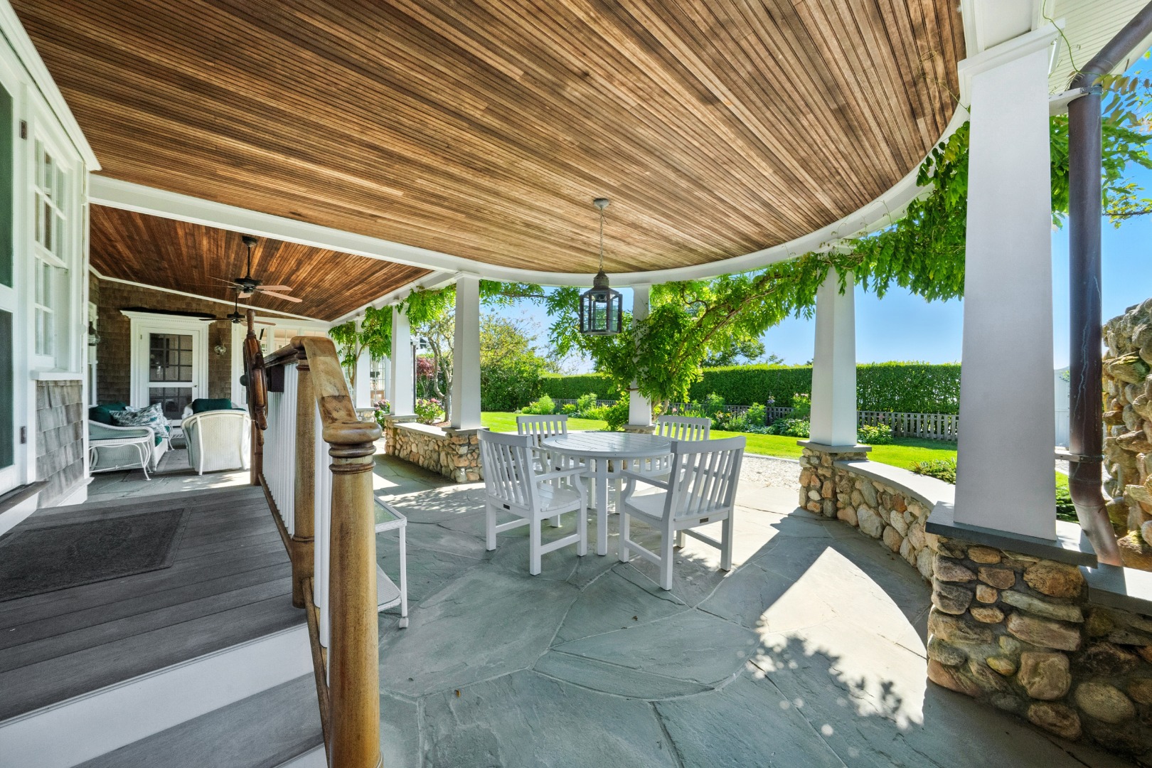 1 Ocean Avenue Nantucket, MA 02554 - Photo 17 of 49 a view of a patio with table and chairs potted plants with wooden floor and roof