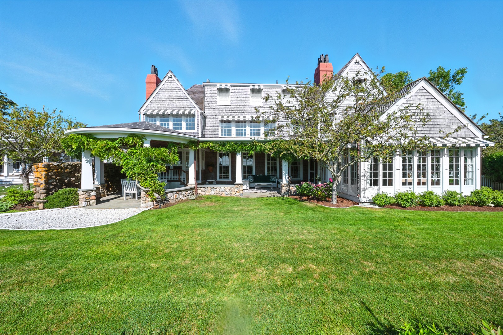 1 Ocean Avenue Nantucket, MA 02554 - Photo 3 of 49 a view of a house with a yard and table and chairs under an umbrella