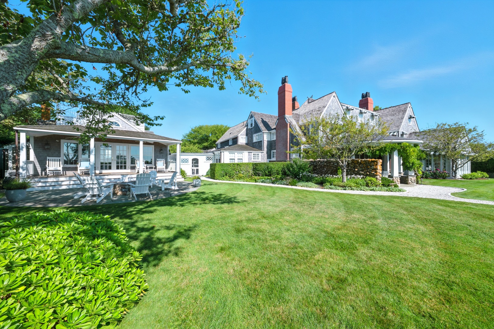 1 Ocean Avenue Nantucket, MA 02554 - Photo 35 of 49 a front view of a house with a yard table and chairs