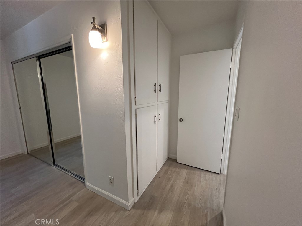 25091 La Cresta Drive, Unit B Dana Point, CA 92629 - Photo 14 of 30 a view of a hallway with wooden floor