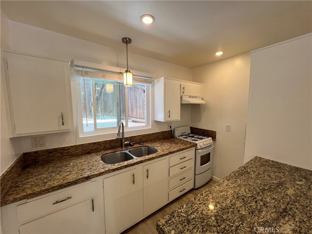 25091 La Cresta Drive, Unit B Dana Point, CA 92629 - Photo 3 of 30 a kitchen with granite countertop a stove a sink and a granite counter tops