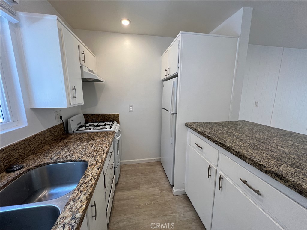 25091 La Cresta Drive, Unit B Dana Point, CA 92629 - Photo 8 of 30 a kitchen with stainless steel appliances granite countertop a sink stove and refrigerator