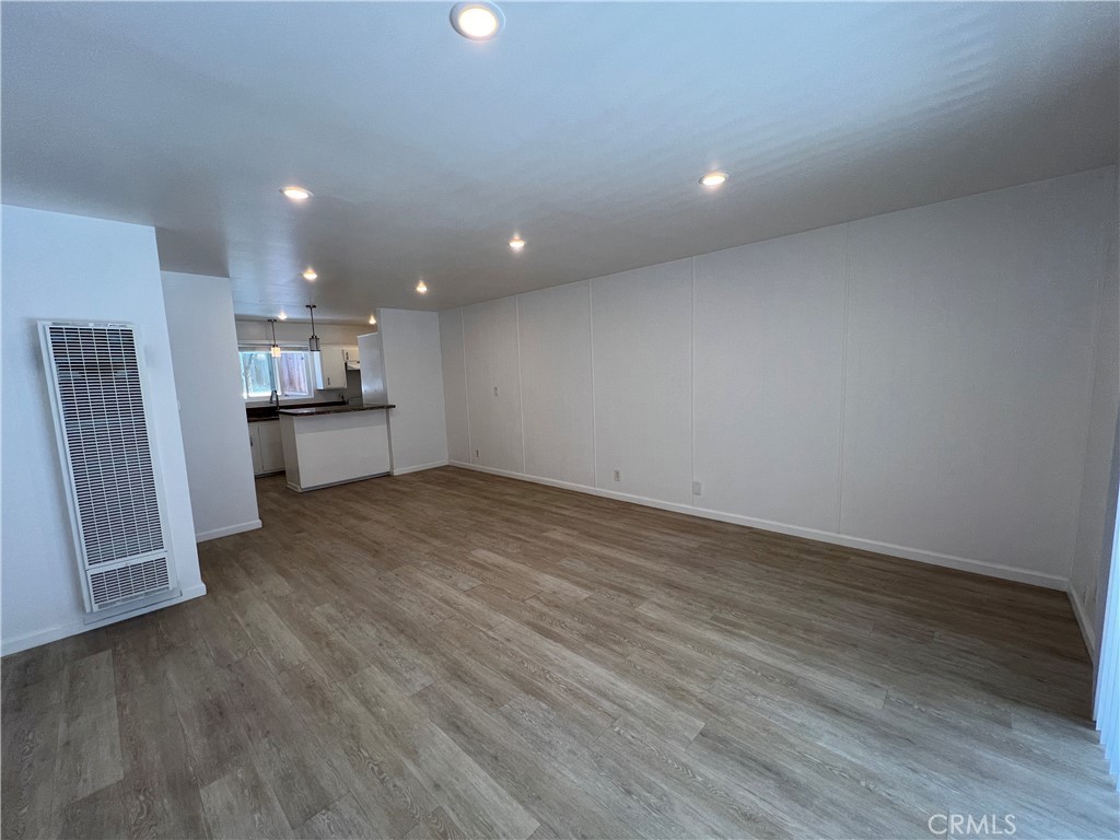 25091 La Cresta Drive, Unit B Dana Point, CA 92629 - Photo 9 of 30 an empty room with wooden floor and a window