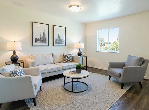 a living room with furniture a rug and a window