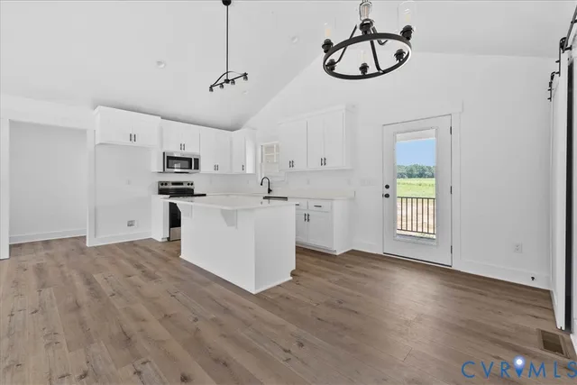 a view of kitchen with wooden floor cabinets and window