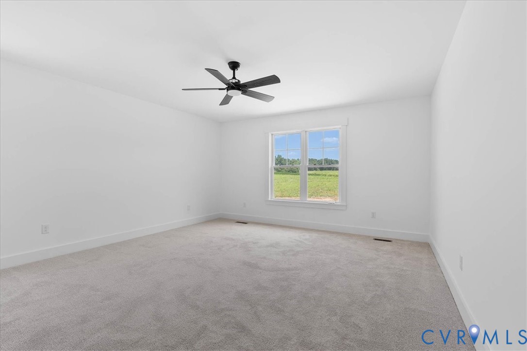 20055 Log Road Disputanta, VA 23842 - Photo 22 of 27 an empty room with windows and ceiling fan