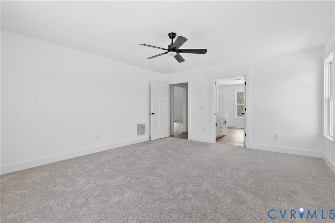 20055 Log Road Disputanta, VA 23842 - Photo 23 of 27 an empty room with closet and windows