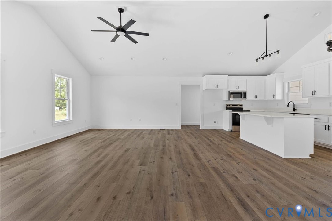 20055 Log Road Disputanta, VA 23842 - Photo 5 of 27 a view of a kitchen with a sink dishwasher a refrigerator and wooden floor