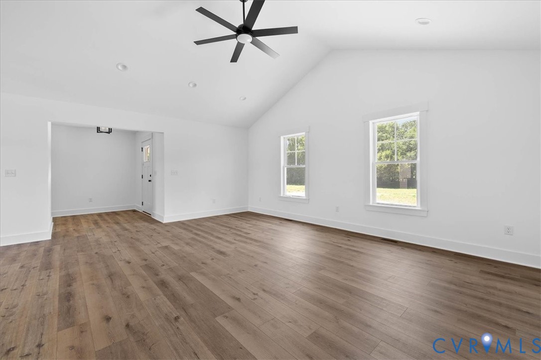 20055 Log Road Disputanta, VA 23842 - Photo 8 of 27 a view of empty room with wooden floor and fan