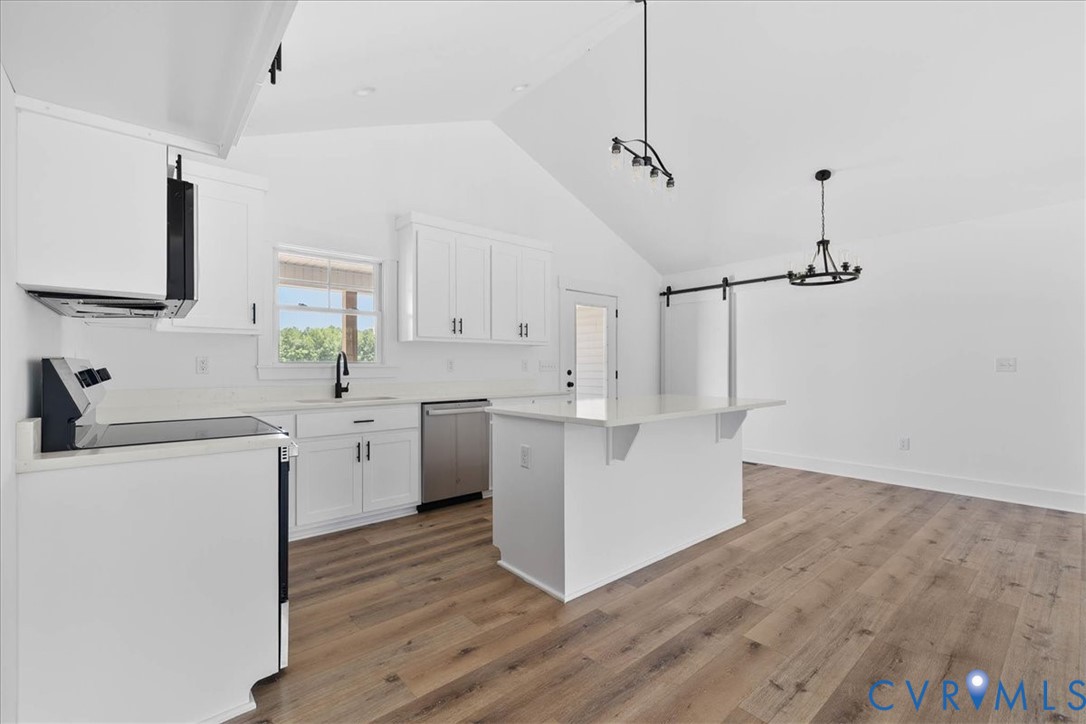 20055 Log Road Disputanta, VA 23842 - Photo 9 of 27 a kitchen with sink cabinets and wooden floor