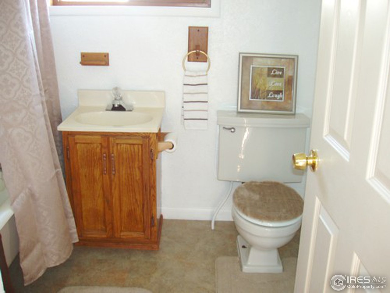 521 Lincoln Street Fort Morgan, CO 80701 - Photo 11 of 12 a bathroom with a sink and a toilet