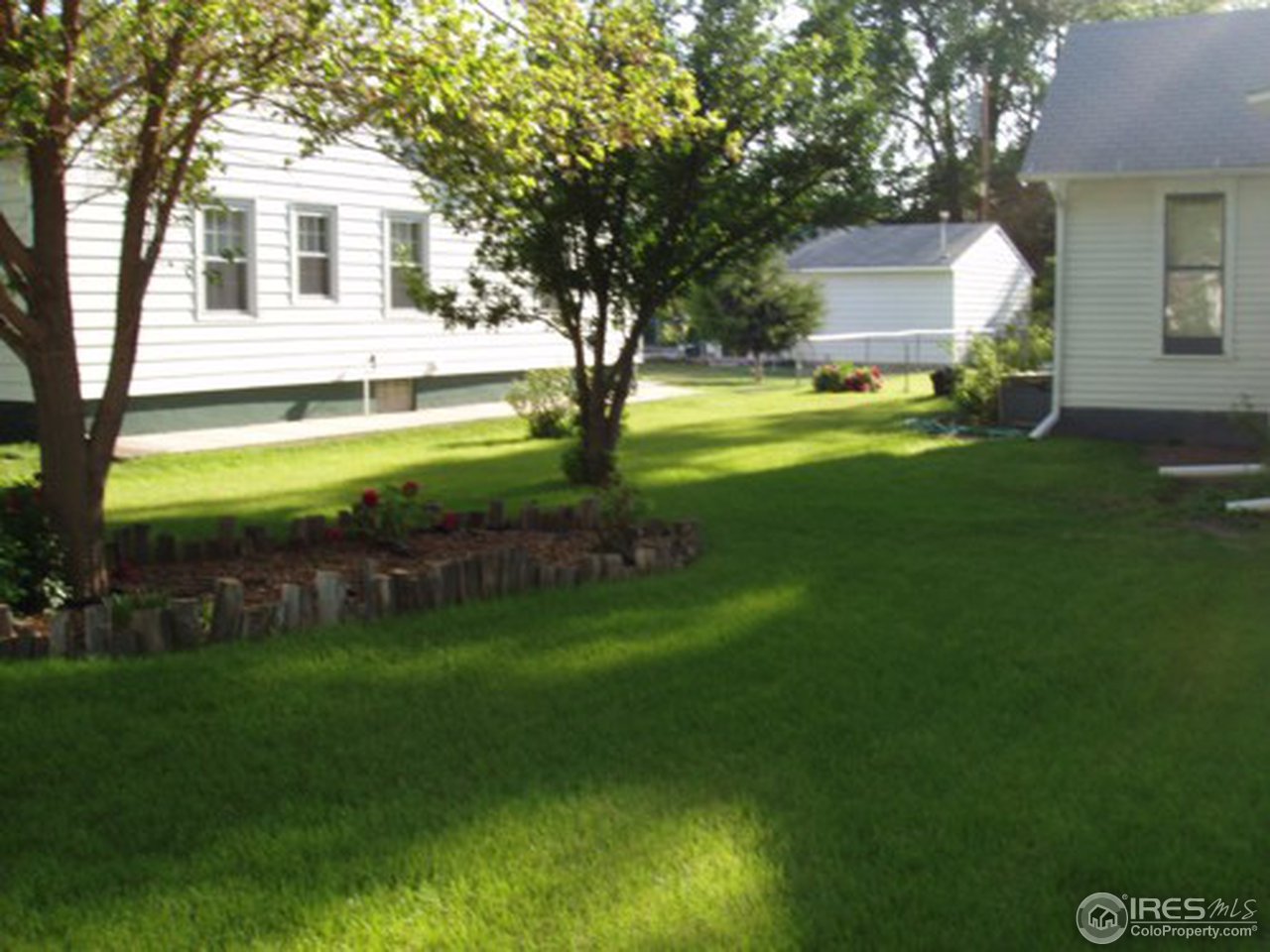 521 Lincoln Street Fort Morgan, CO 80701 - Photo 3 of 12 a front view of a house with garden