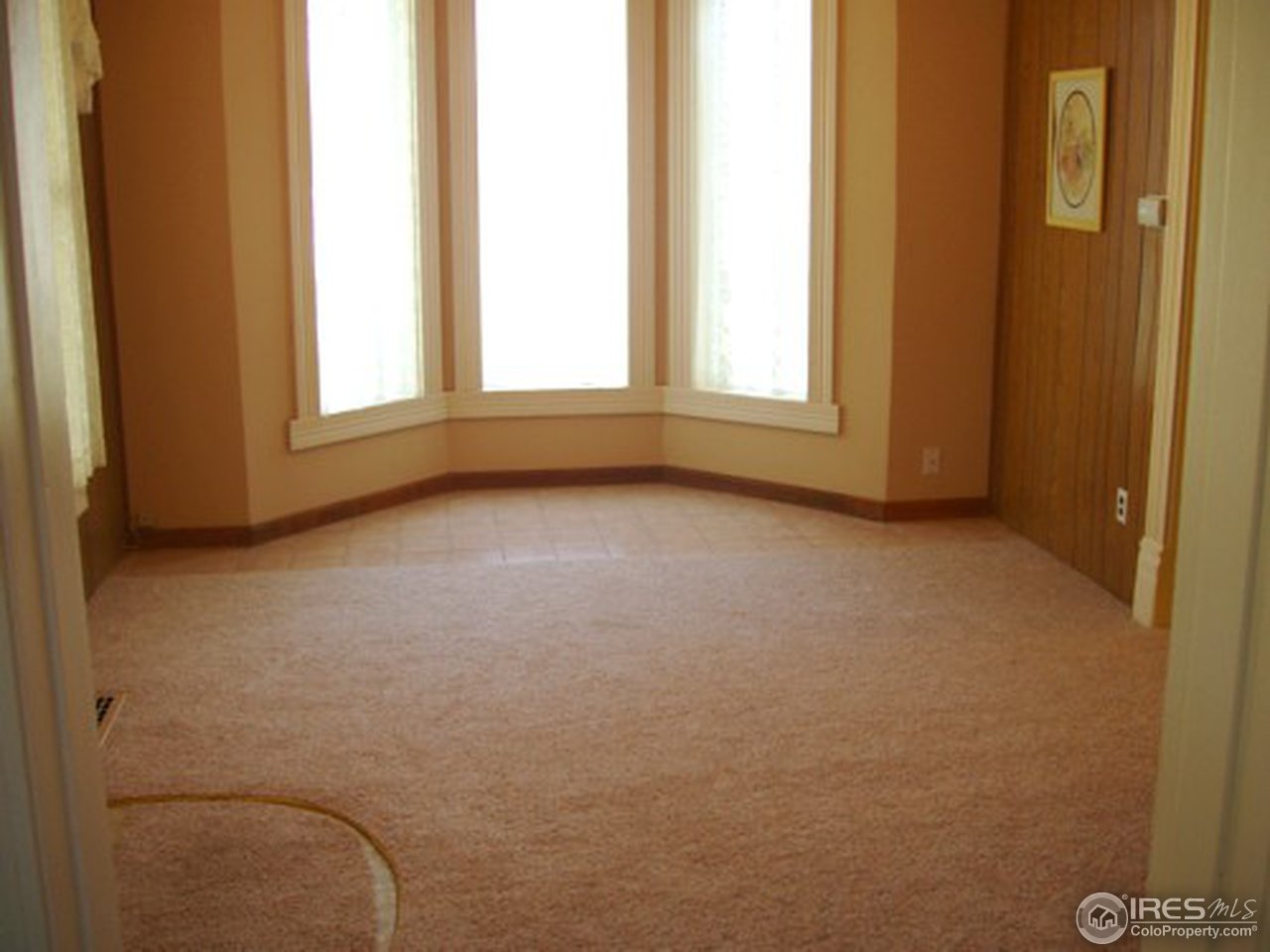 521 Lincoln Street Fort Morgan, CO 80701 - Photo 9 of 12 a view of an empty room with a window