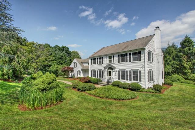 819 Old Academy Road Fairfield, CT 06824 - Photo 1 of 1 a front view of a house with a garden